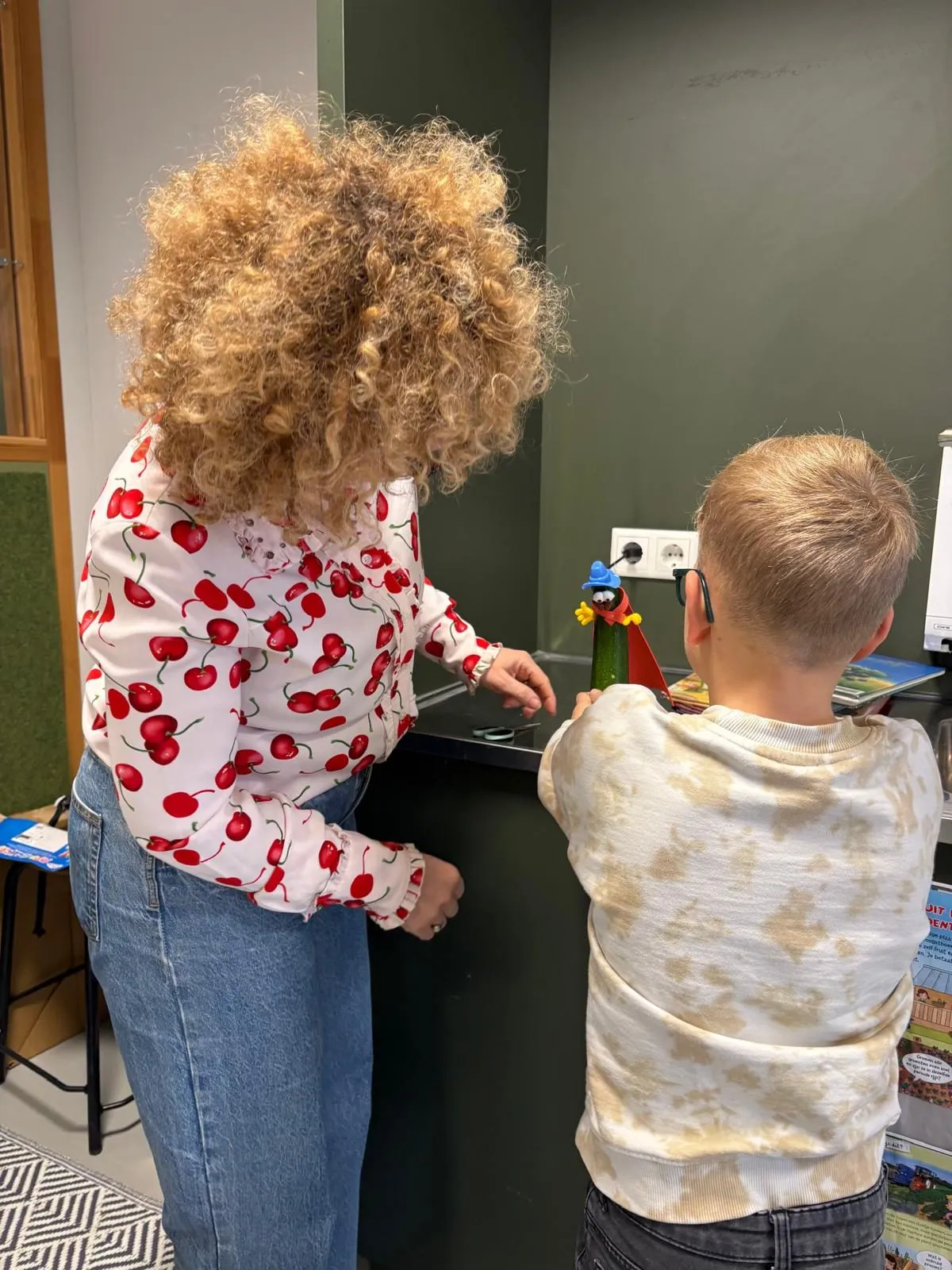 Twee leerlingen zetten hun held klaar voor de foto